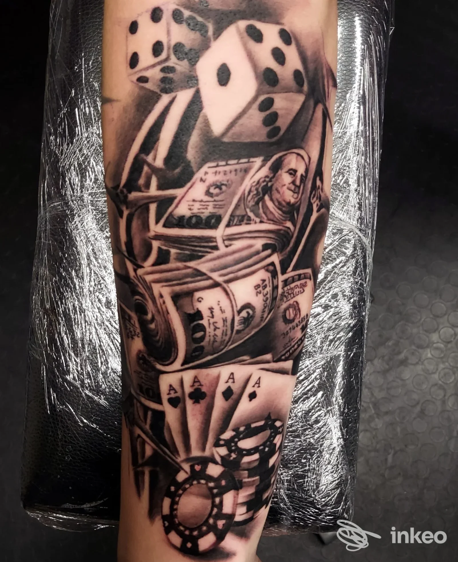 Tatuaggio in bianco e nero su avambraccio con dadi, banconote, carte e gettoni — Il_Pipi_tattoo, Santa Maria degli Angeli.