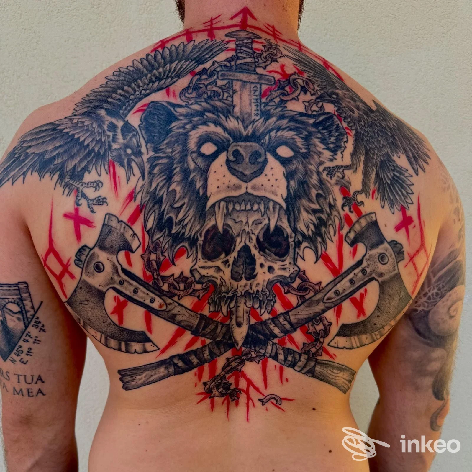Grande tatuaggio sulla schiena con testa d'orso, teschio e asce incrociate, opera condivisa dallo studio FiArt tattoo, Malo.