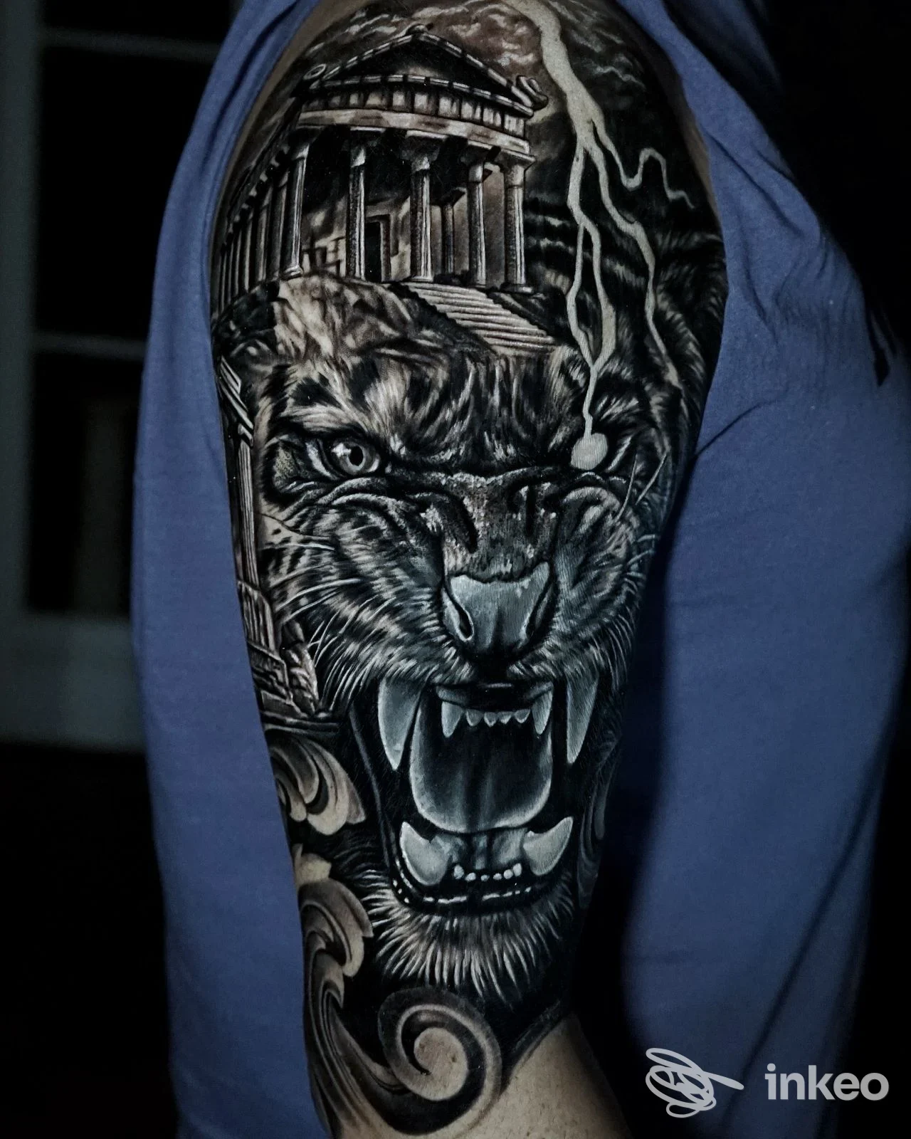 Tatuaggio realistico in bianco e nero di una testa di tigre e un tempio sulla spalla; L'ink Tattoo Studio, Cadoneghe.