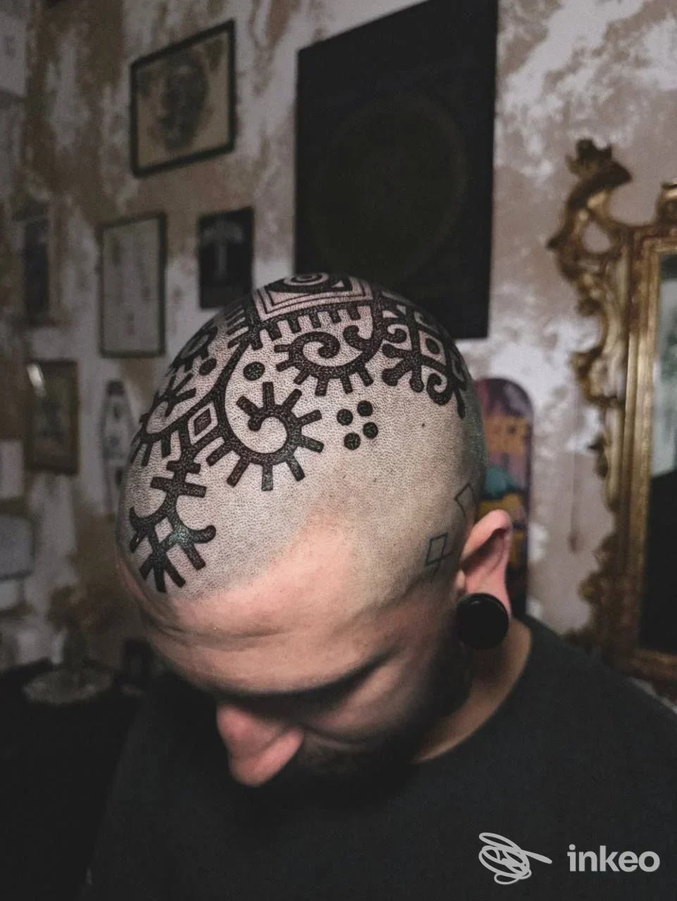 Tatuaggio grafico nero sul cuoio capelluto di un cliente nello studio Lux Aeterna Tattoo Studio a Mussolente.