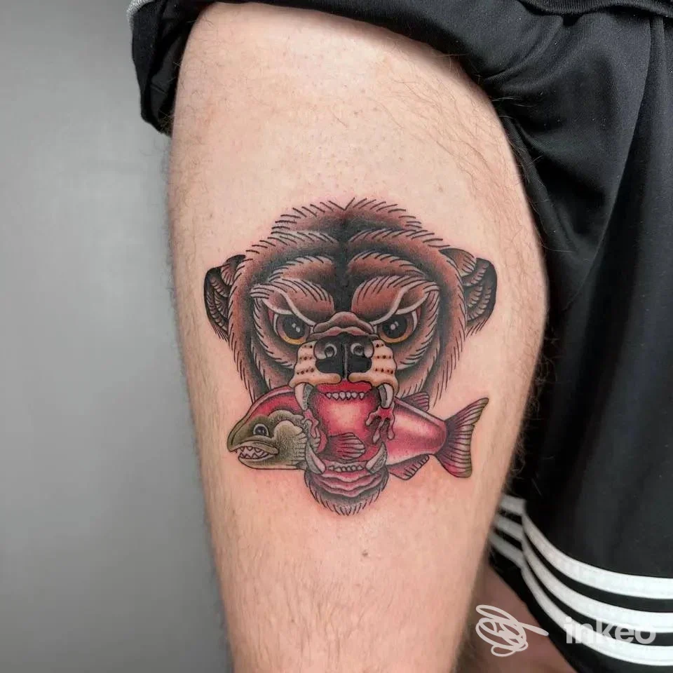 Tatuaggio su coscia con volto di orso che morde un pesce, foto inviata dallo studio Mamma Non Vuole Tattoo Ink a Monteforte d'Alpone.