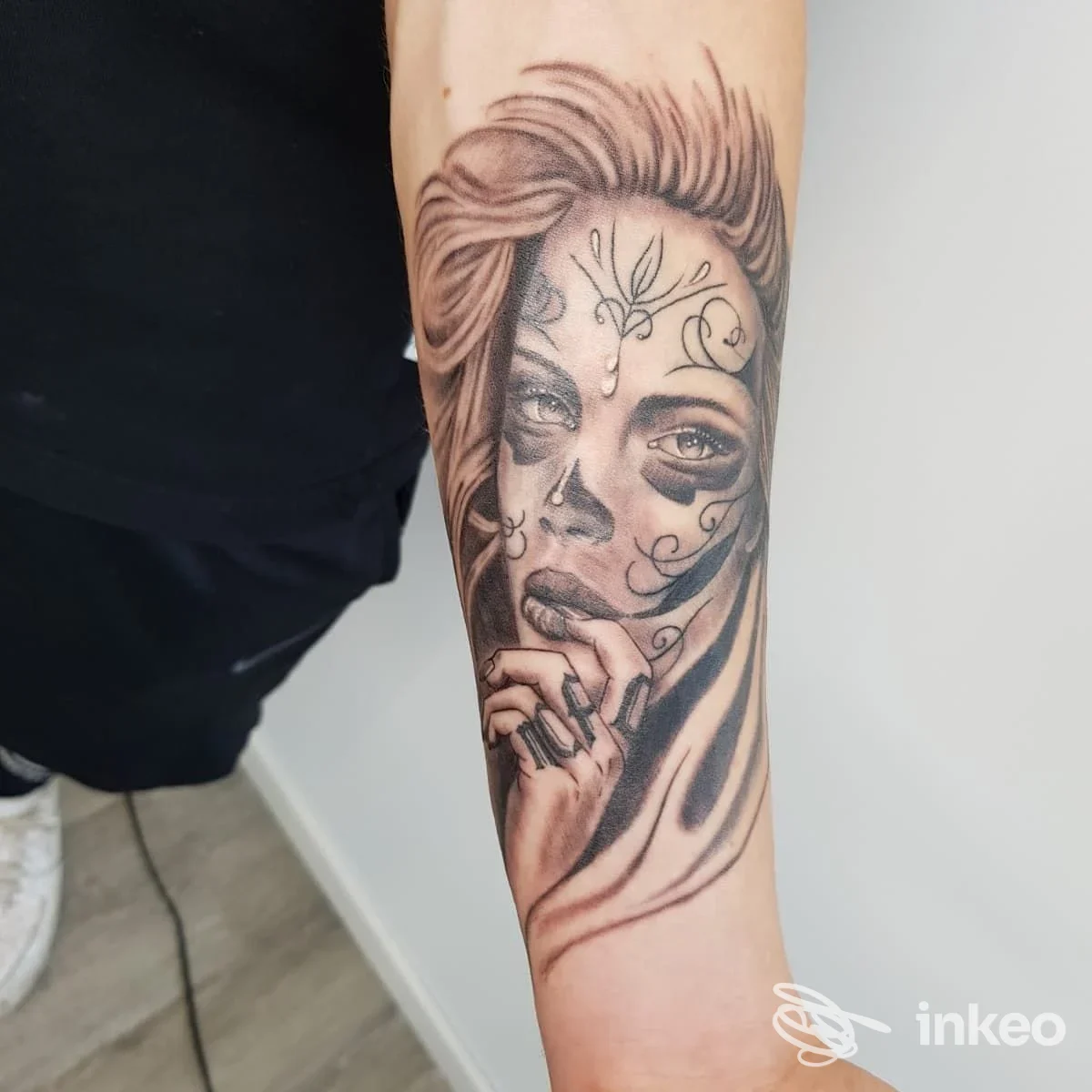 Ritratto femminile in bianco e nero tatuato sull'avambraccio con dettagli del volto e della mano. Lavoro eseguito da Sottopelle Tattoo Studio a Romano d'Ezzelino.