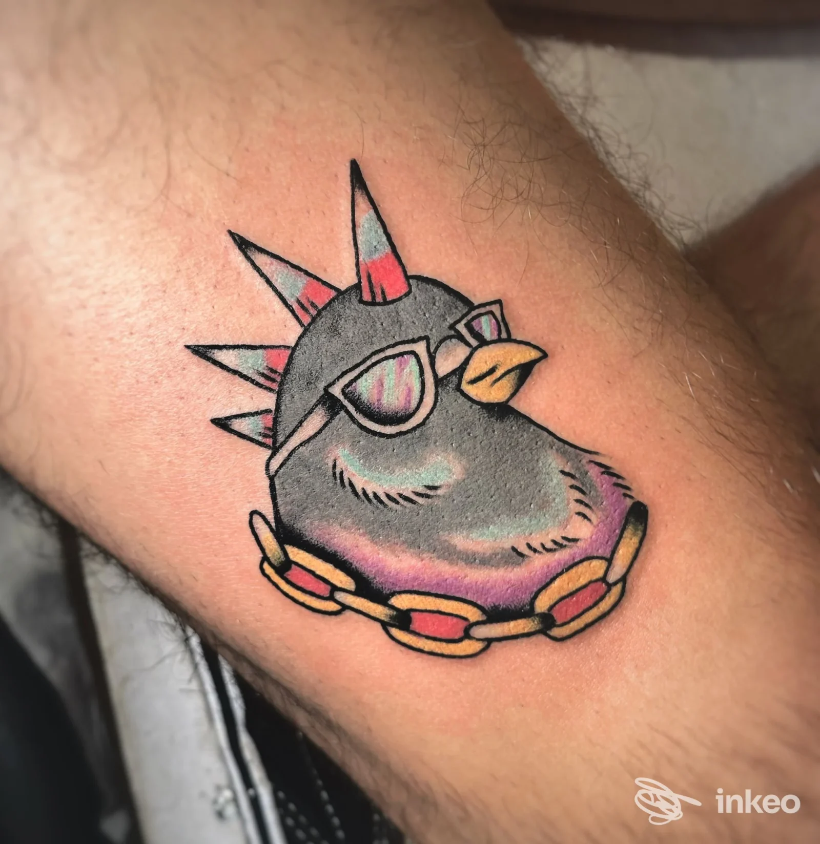 Tatuaggio colorato di un uccello stilizzato su avambraccio, Bunkerino Tattoo Shop, Venezia.