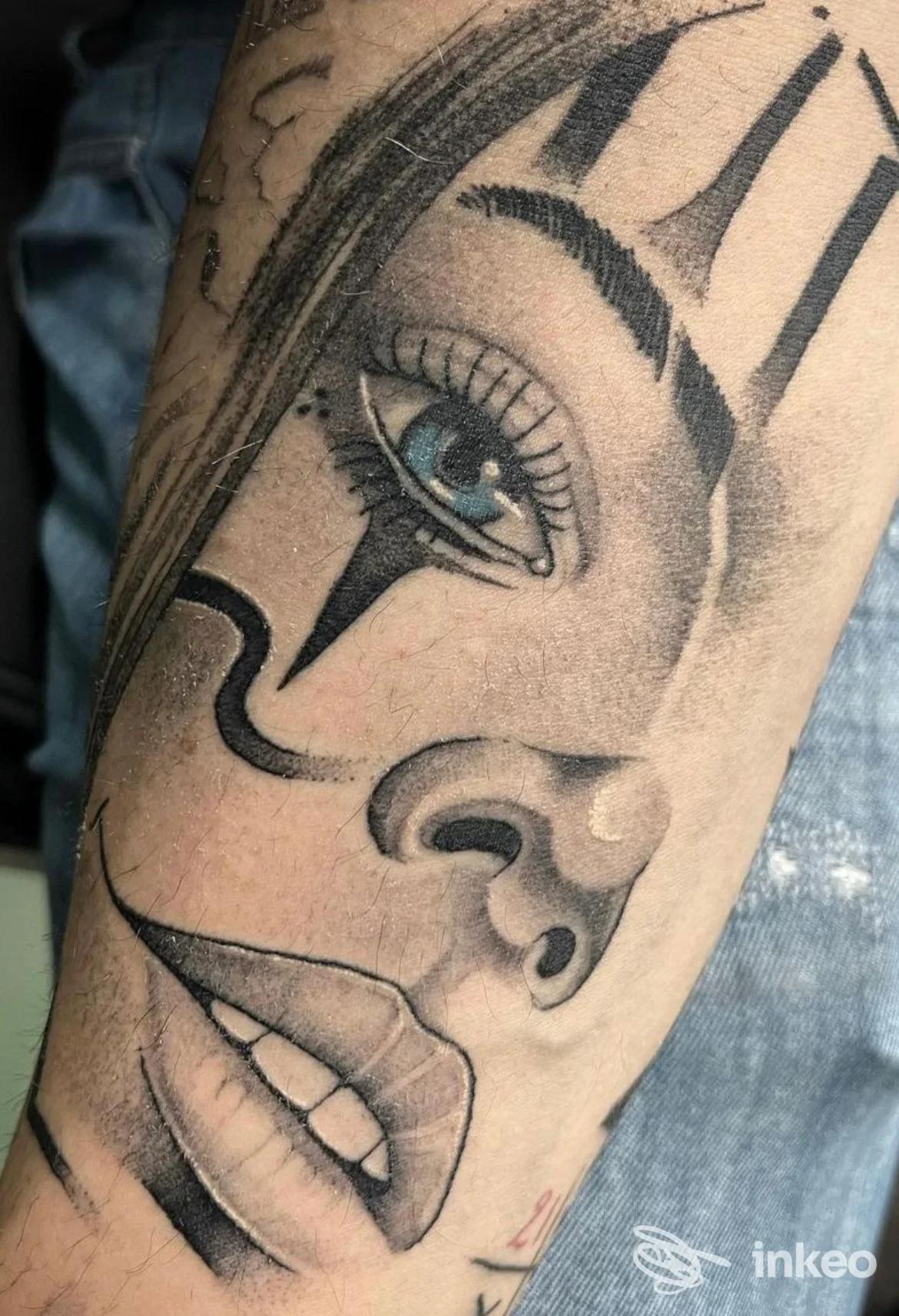 Primo piano di un tatuaggio realistico su avambraccio raffigurante un volto femminile con occhio azzurro, Studio 69 Tattoo, Matera.