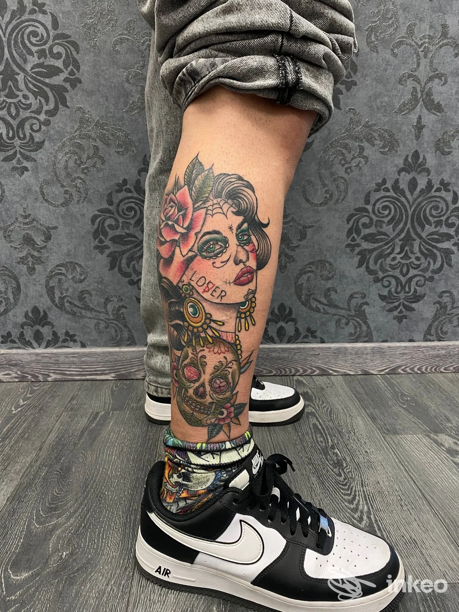 Tatuaggio polpaccio con volto femminile e teschio, fotografia eseguita da Cherry Tattoo & piercing, Imola.