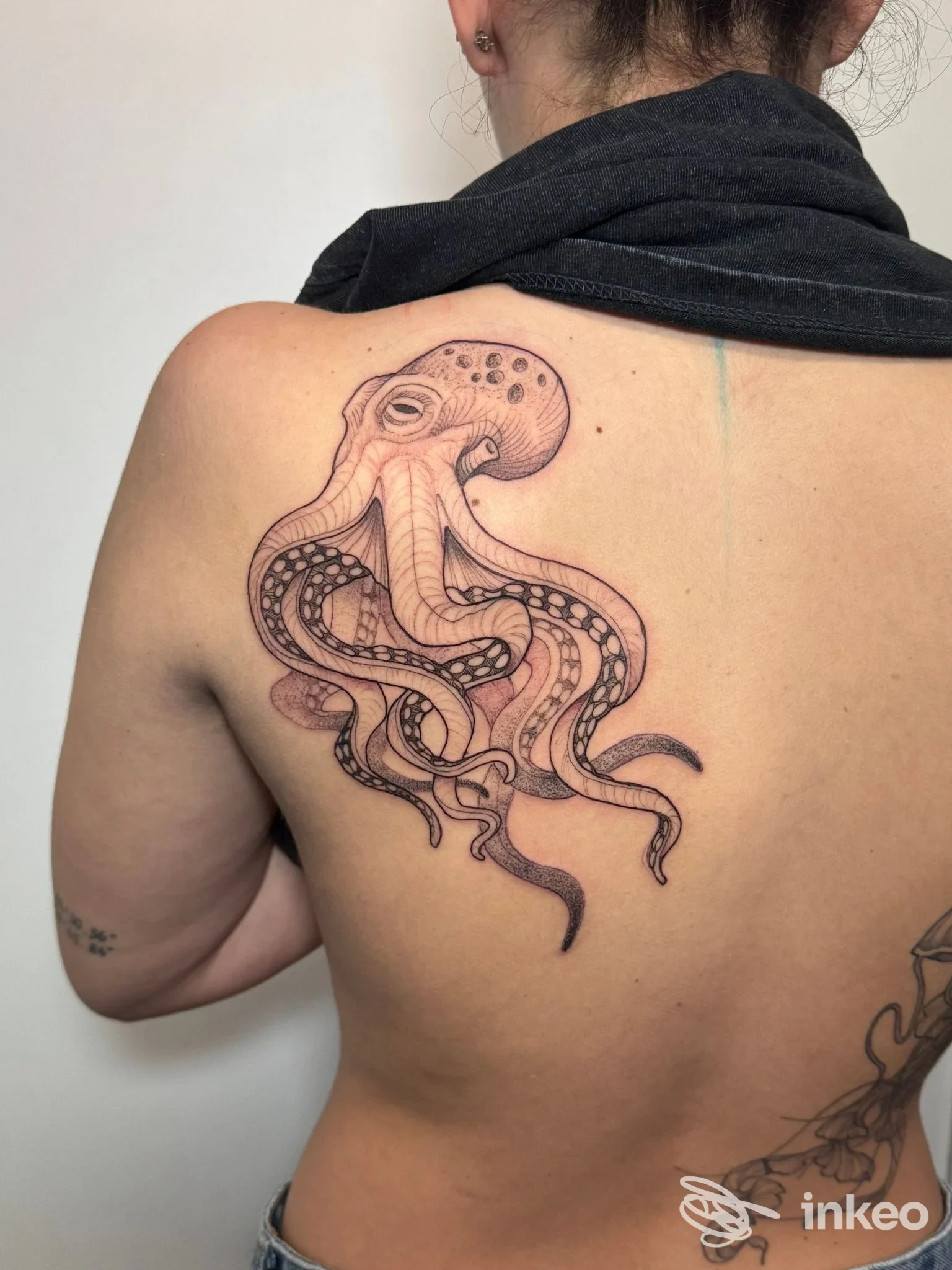 Tatuaggio di un grande polpo stilizzato sulla parte alta della schiena; immagine fornita da Zero Tattoo Studio, Prato.