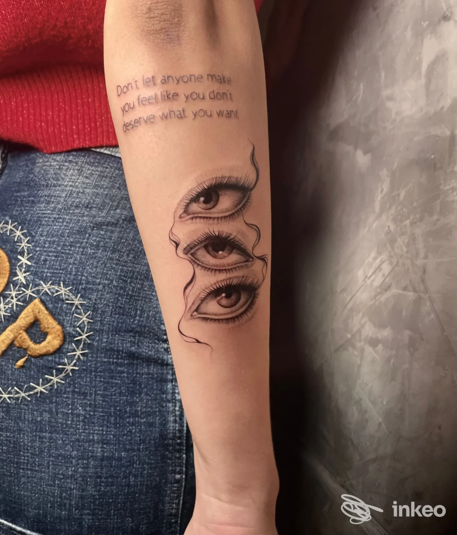 Avambraccio con tatuaggio di tre occhi sovrapposti e scritta; foto dallo studio Laguna Tre TATTOO, Forlì.