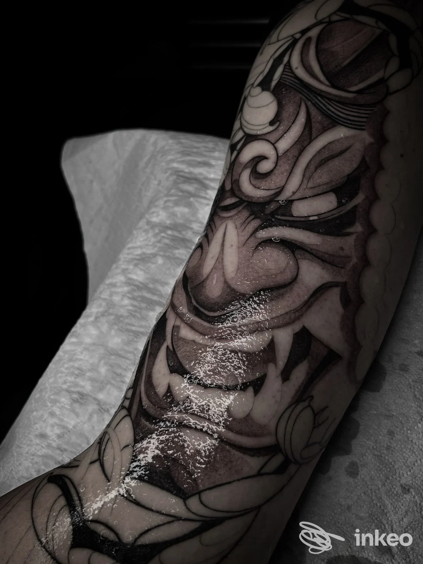 Tatuaggio ornamentale scuro su avambraccio, foto inviata da Contrasto Ink a Trecate che mostra dettagli di linee e ombreggiature.