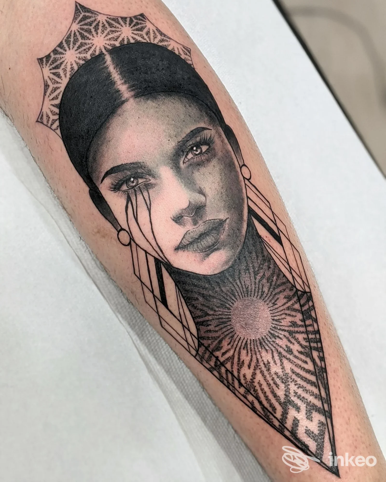 Ritratto femminile tatuato sull'avambraccio con motivi geometrici e texture solari, lavoro in bianco e nero di Danjotattoo a Isola del Liri.