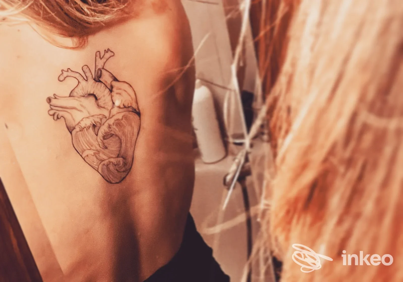 Tatuaggio anatomico a forma di cuore sulla parte superiore della schiena, foto realizzata da Baku Tattoo Roma a Roma.