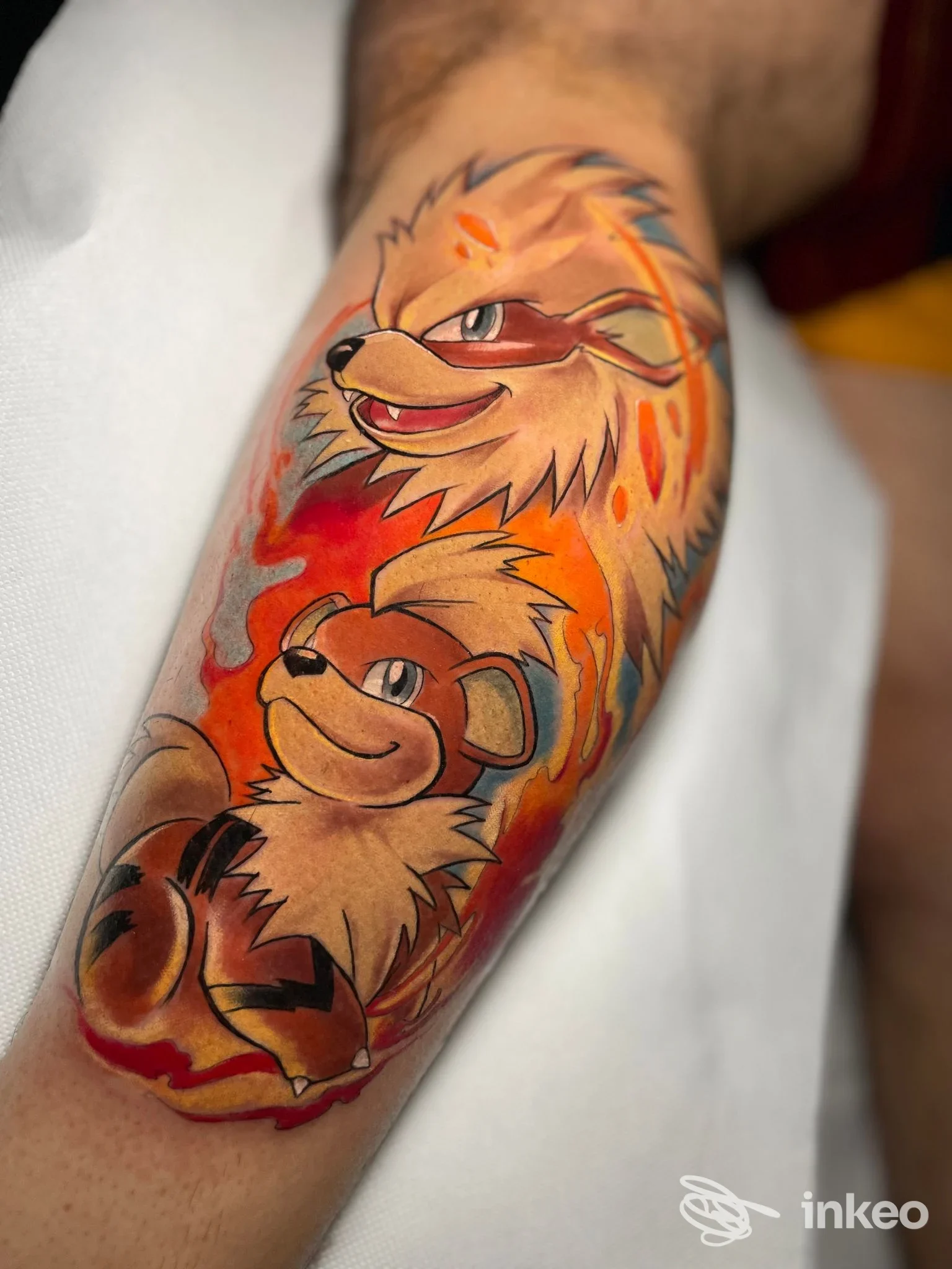 Tatuaggio colorato di due personaggi su avambraccio, foto realizzata per Hermesink Genova.
