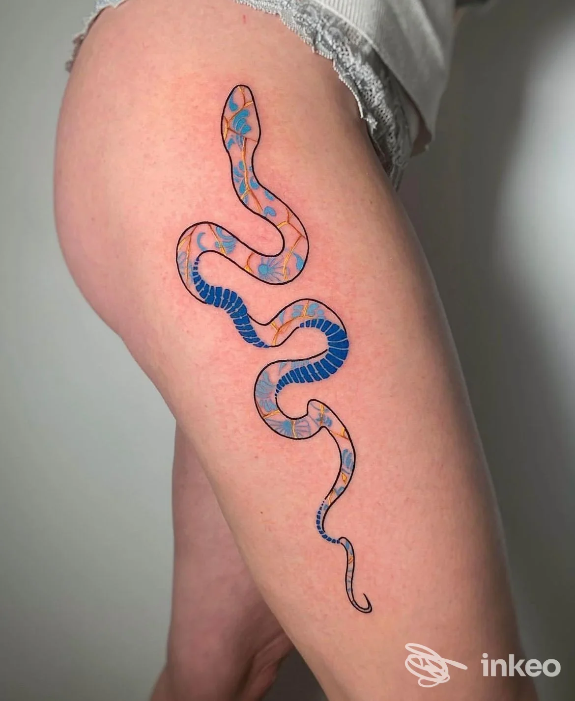Tatuaggio serpente colorato e sinuoso sulla coscia, fotografia professionale — Avant-Garde Ink Tattoo & Piercing, Sona.