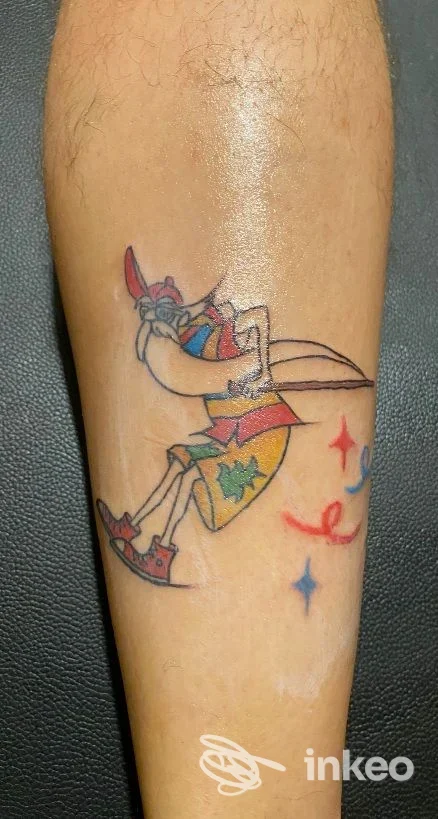 Tatuaggio colorato stile cartone sul polpaccio fotografato per portfolio di Ehawee Estetica & AR Tattoo, Cento.