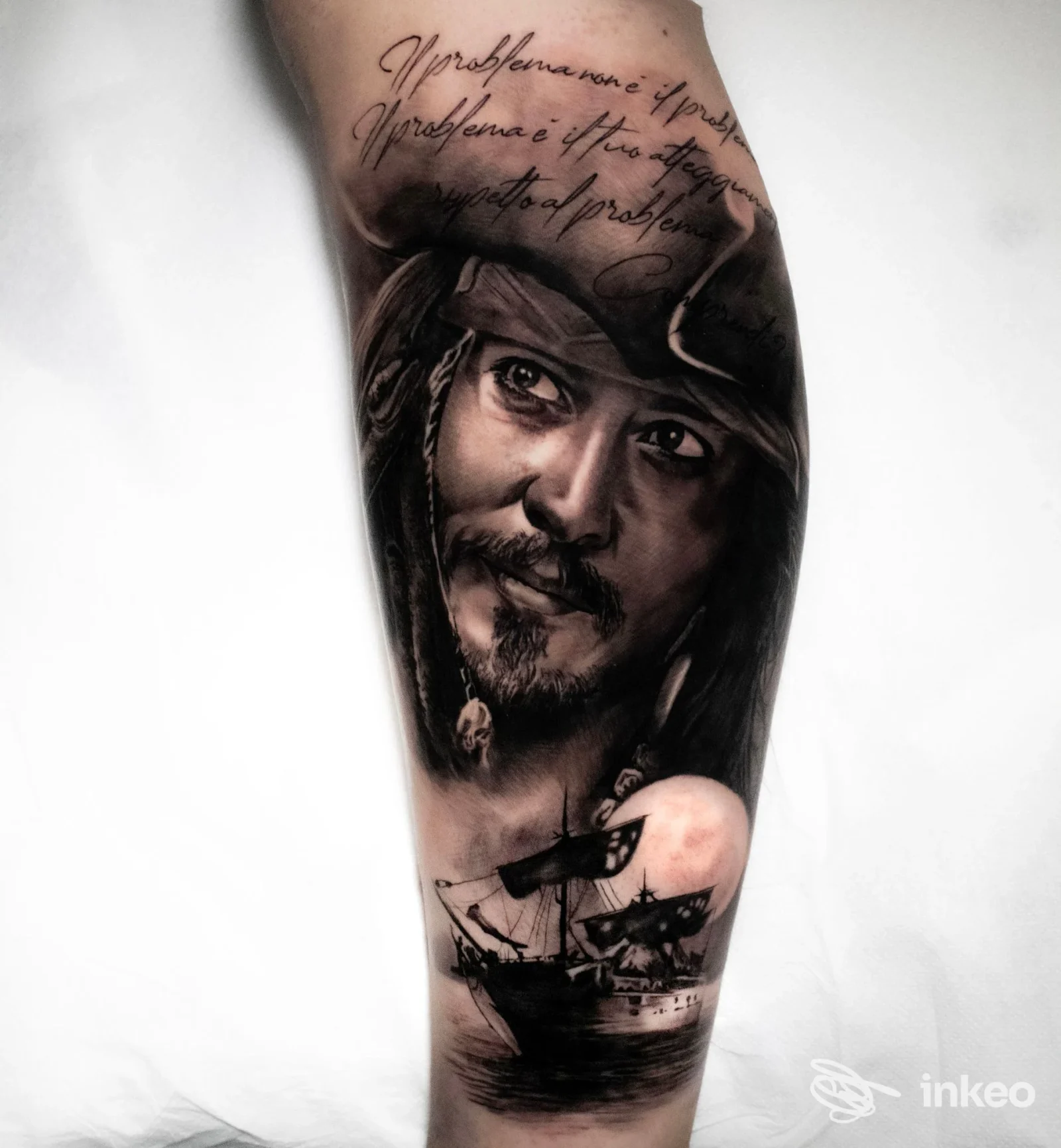 Tatuaggio realistico raffigurante un ritratto e una nave sull'avambraccio, eseguito da Red Ink Tattoo studio a Lariano.
