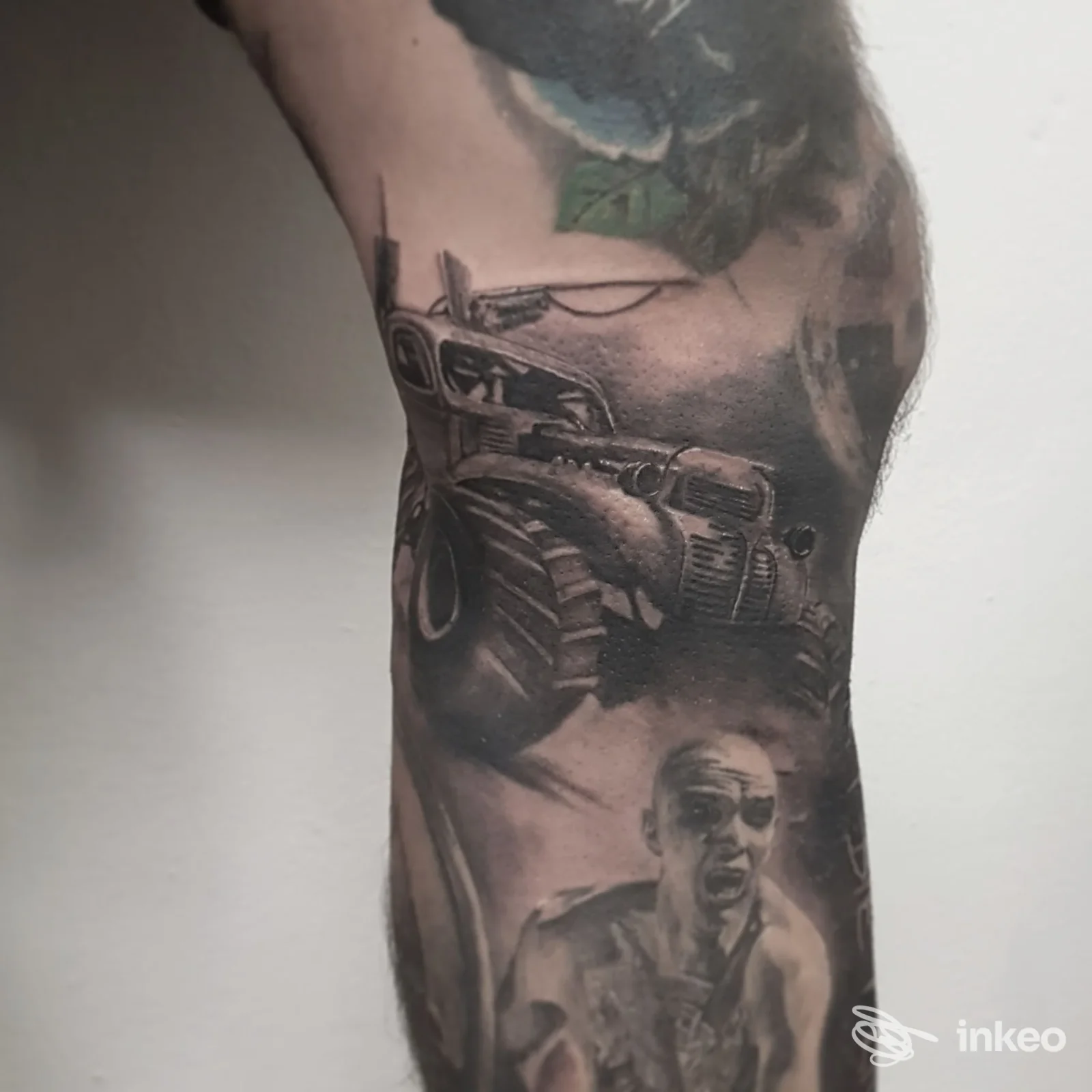 Tatuaggio realistico su braccio raffigurante un veicolo e una figura umana, eseguito direttamente sulla pelle. Studio Sweet Killer Tattoo Studio, città non specificata.