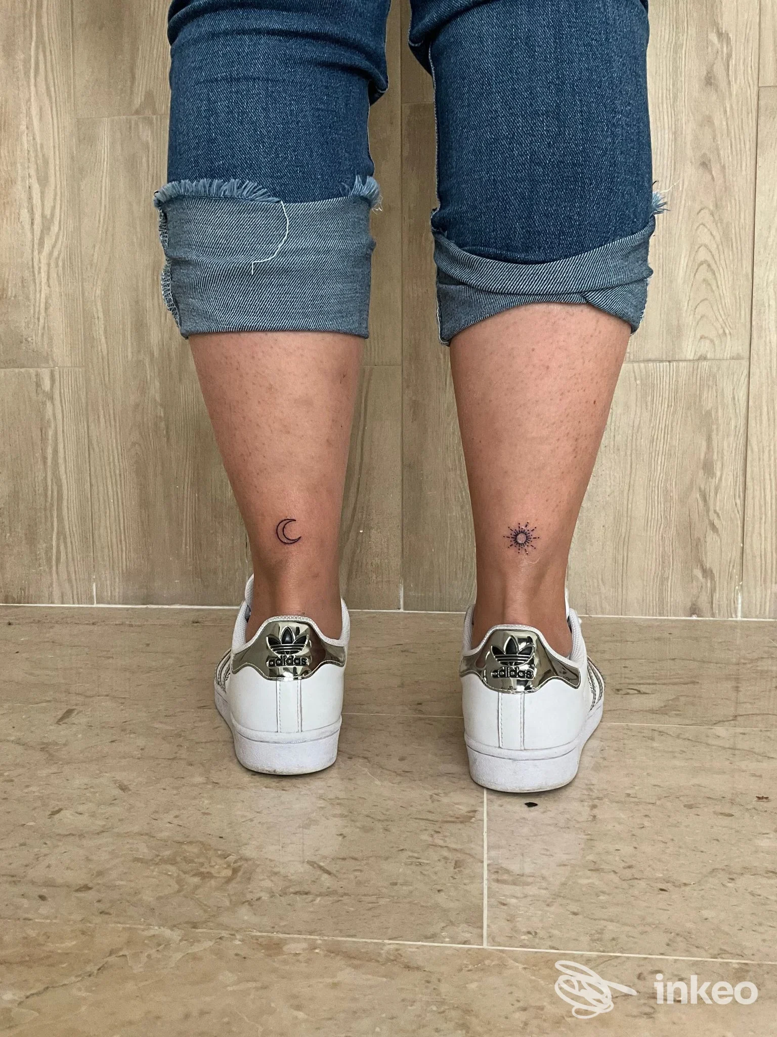 Due piccoli tatuaggi minimal sulle caviglie (luna a sinistra, sole a destra). Ale Ink, Trappeto.