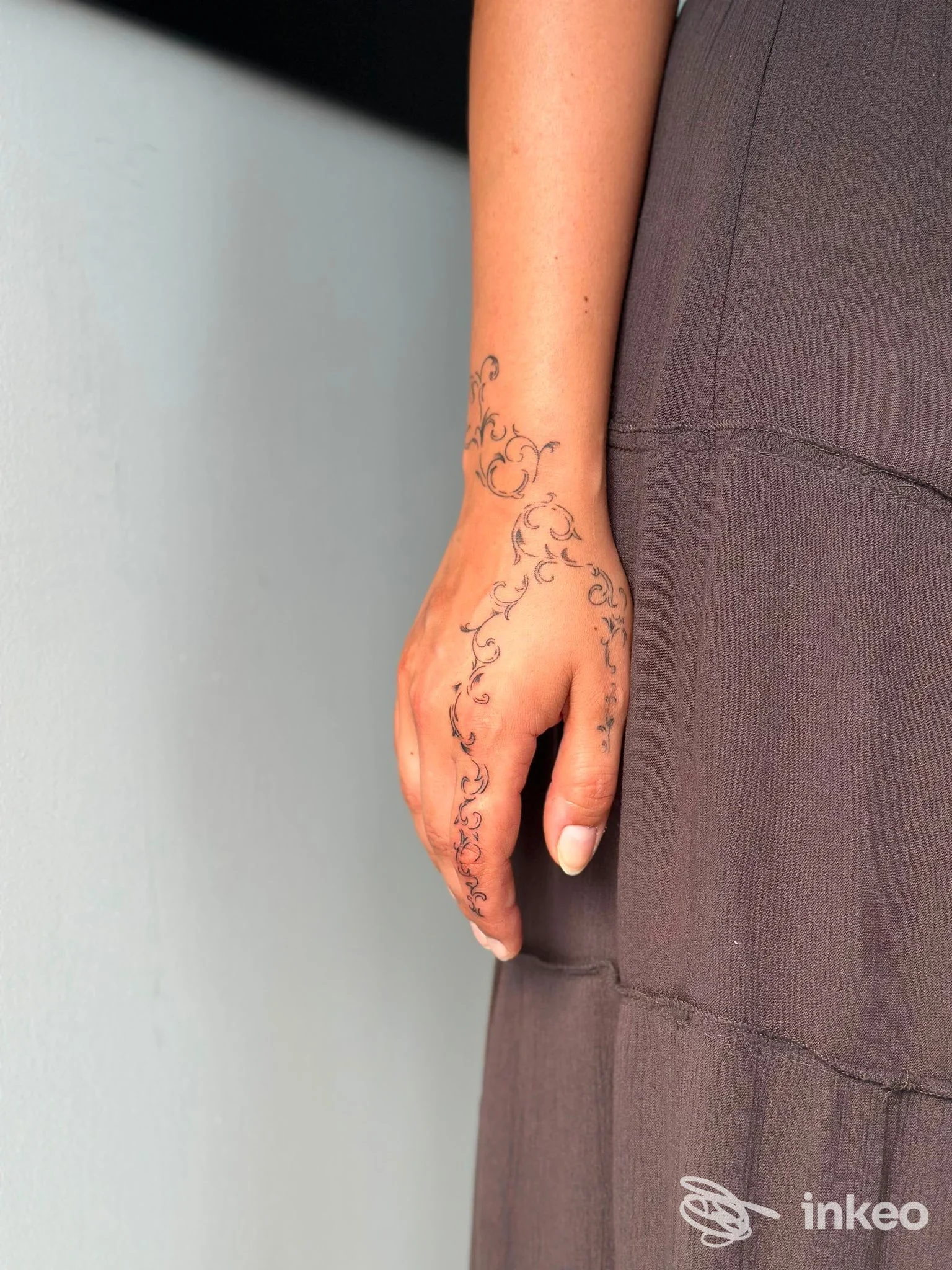 Primo piano di una mano tatuata con motivi floreali, foto per nerocorpus a Quinto di Treviso.